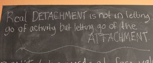 Photo of the sign in my office, "Real detachment is not in letting go of activity but letting go of the attachment."