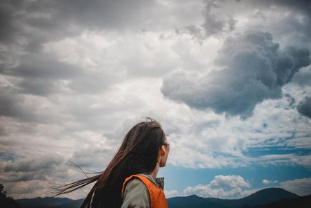 Woman gazing at ominous clouds - representing observing emotions 