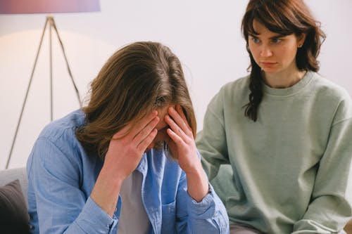 woman upset with a friend listening