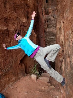 Playful photo of woman in tree pose between two rocks