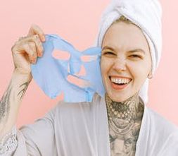 Woman peeling off her face mask