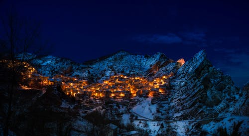 glowing lights of a small mountain town at night