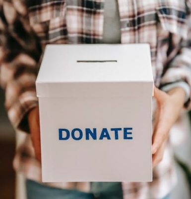 Person holding a donate box