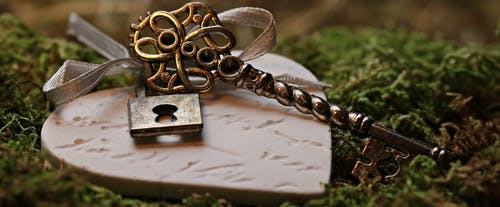 ceramic heart with ornate key resting on it