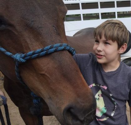 Boy talking to a horse