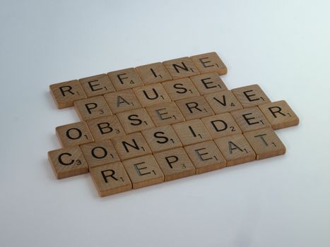 Scrabble pieces spelling out refine, pause, observe, consider, repeat