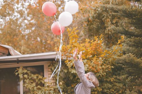 woman letting go of balloons