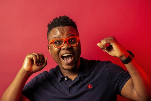 man with an expression of "yes, I can" with red background