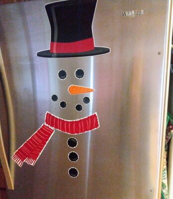 refrigerator with snowman hat, eyes, nose, mouth, scarf, and button magnets