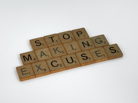 Scrabble letters spelling out stop making excuses