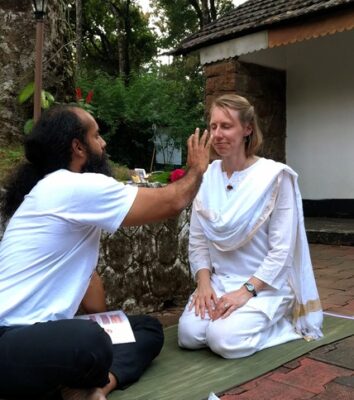 The author being blessed by her teacher after a Meditation Facilitator Training in 2019