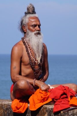 Indian Yoga sadhu in mediation by the ocean