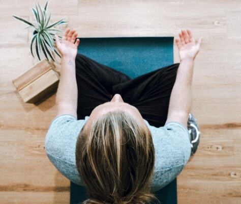 top down view of a woman in meditation to cultivate a peaceful mind