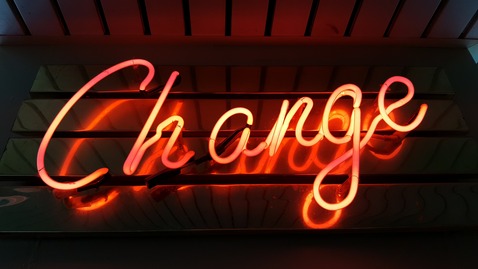 Neon orange sign that says change