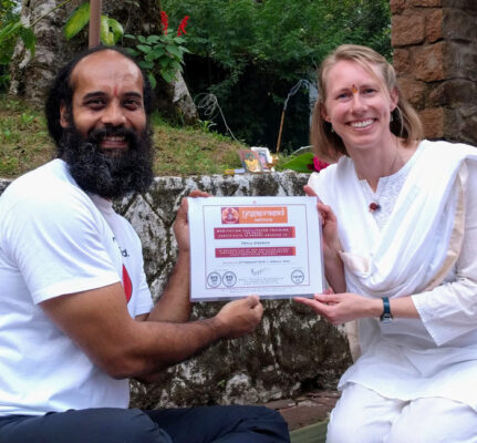 Author with Prasad Rangnekar receiving a certificate for a meditation facilitator training.