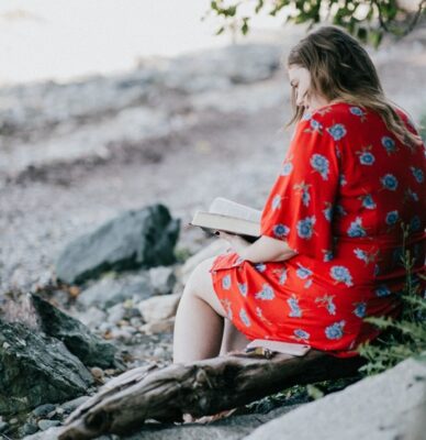 woman sitting in nature reading and reflecting as a practice of kriya yoga