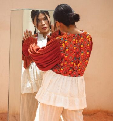 woman looking honestly and directly at herself in a mirror to connect with her truth