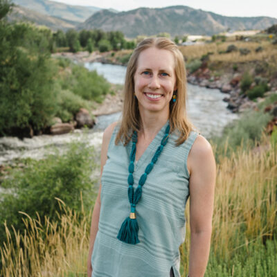 Author headshot with river and hills in the background