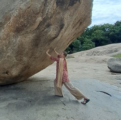 woman pushing a big rock that won't budge, using the wrong technique to move the rock and calm her mind