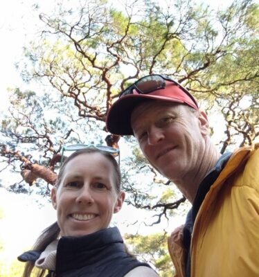 Author and her partner beneath a spectacular tree canopy