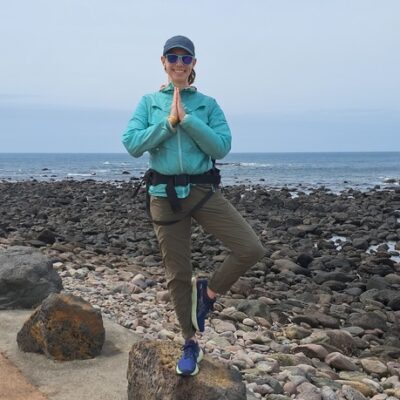 photo of author in vrikasana tree pose by the ocean with a calm mind