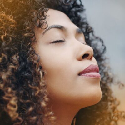 close up of woman's face with eyes closed relaxed with acceptance