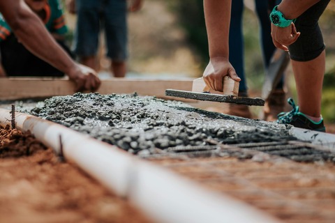 closeup of putting in a foundation of cement on which to build