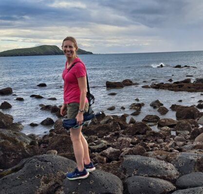 Author enjoying a walk by the ocean for some evening self-care