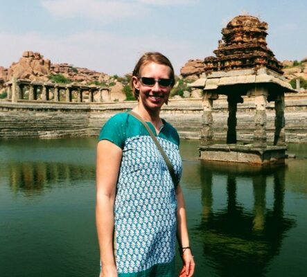 author in front of ruins in Hampi where she discovered to find calm she needed to face herself