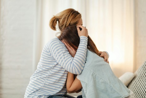 woman comforting her child going through a painful time