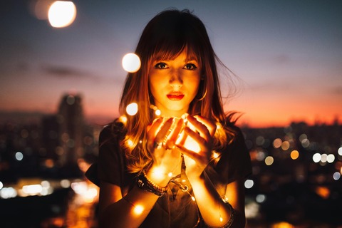 woman with cupped hands holding light representing her inner wisdom