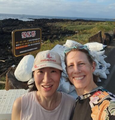 author and friend at the end of a beach clean up smiling with satisfaction