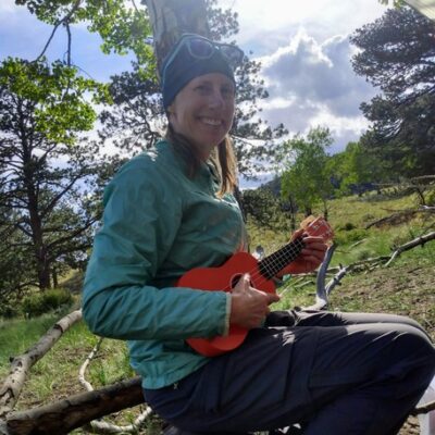 author enjoying playing ukulele while backpacking